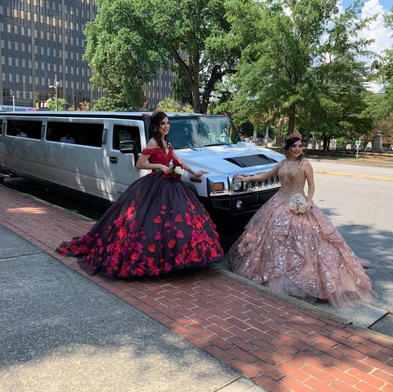 Quinceañera girls posing in front of limo