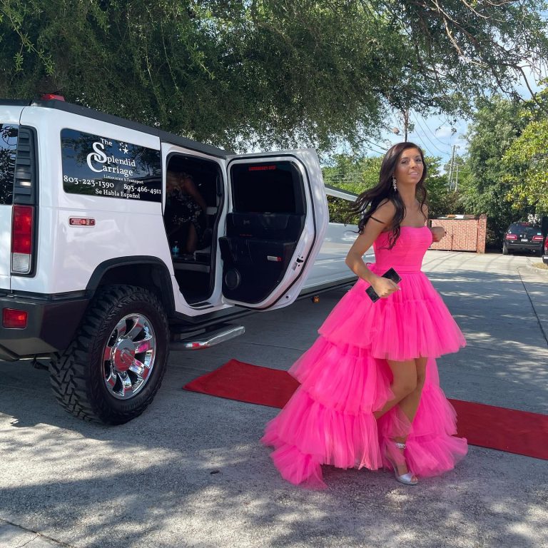 girl walking out of white limo with red carpet