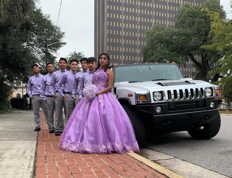 Quinceañera people posing in front of limo