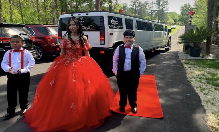 Quinceañera people posing in front of limo